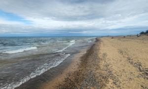 Blustery May day walking beach and looking out over Lake Superior paying homage to crew of the Edmond Fitzgerlad. </br>Whitefish Point, Michigan </br>Recreation. Jack T Norris.