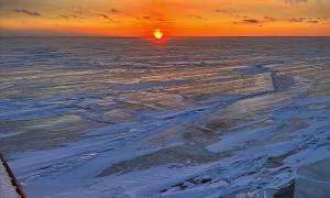 Sunset over the frozen waters of Lake Huron aboard the CCGS Samuel Risley (Canadian ice breaker) while embarking on a winter scientific mission. Lake Huron offshore of Goderich , Ontario. Research, Science, and Education. Joseph Gentile