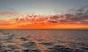 Beautiful sunset and whimsical clouds over the middle of Lake Erie captured during a scientific mission aboard the CCGS Limnos. Lake Erie - near Cleveland , Ohio. Research, Science, and Education. Joseph Gentile.