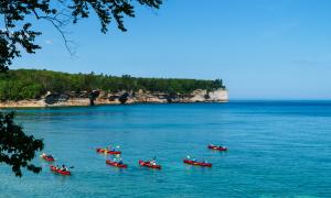 A group a kayakers touring Pictured Rocks National Lakeshore. Pictured Rocks, Michigan. Recreation. Chris Ingham.