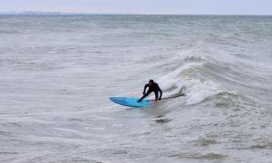 Surfing on Lake Ontario at the Scarborough Bluffs. Scarborough, Ontario. Recreation. Angela Millard.