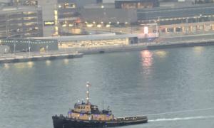 View of a tugboat on the Detroit River. Looking at Detroit, MI from Windsor, CN. Windsor, Ontario. Great Lakes Water in Action. Dawn Schilling.