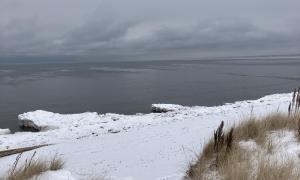 Skiing on windswept snowy dunes on Park Point shore of Lake Superior. Duluth, Minnesota. Recreation. Lisa Fitzpatrick.